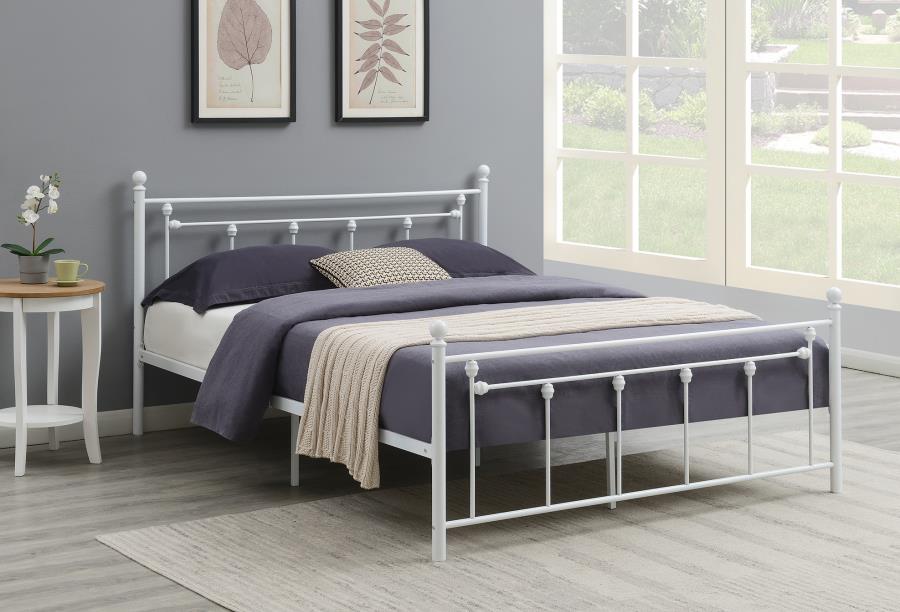 White coloured steel bed with navy blue sheets